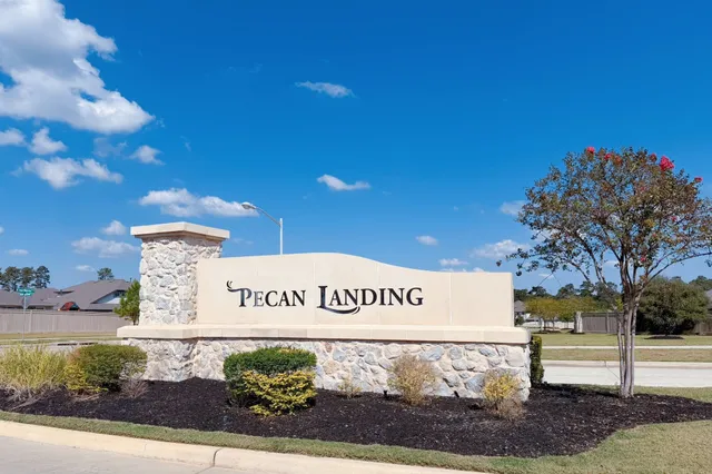 a view of swimming pool with outdoor seating and trees in the background