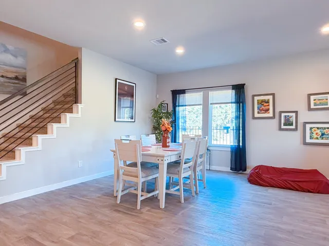 a view of a dining room with furniture window and wooden floor