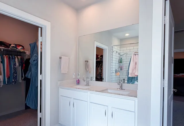 a bathroom with a double vanity sink and a mirror