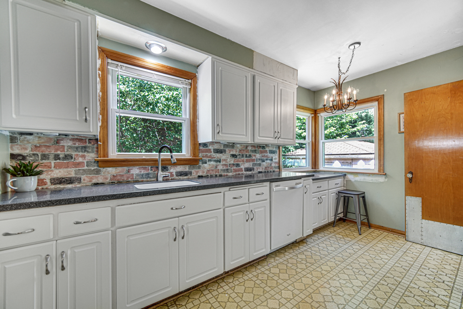 1644 West 187th Street Homewood, IL 60430 - Photo 11 of 24 a kitchen with granite countertop white cabinets and window
