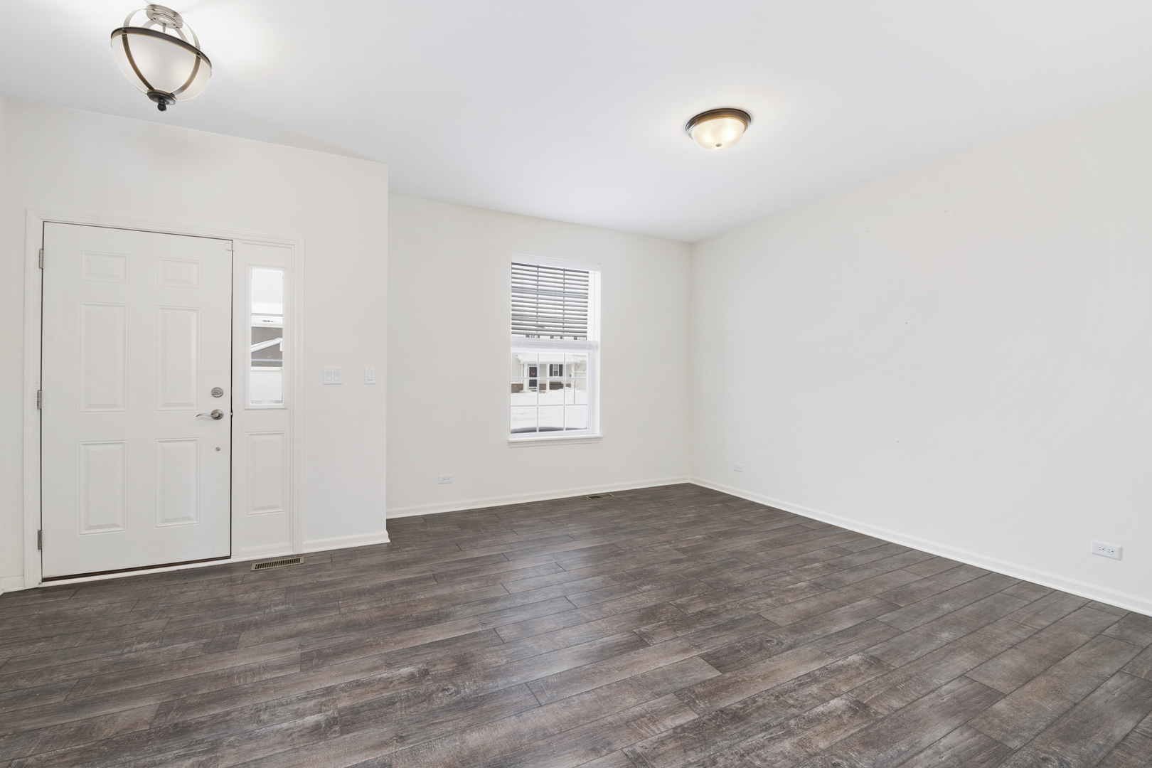 485 Stone Bluff Drive Romeoville, IL 60446 - Photo 2 of 35 a view of an empty room with wooden floor and a window