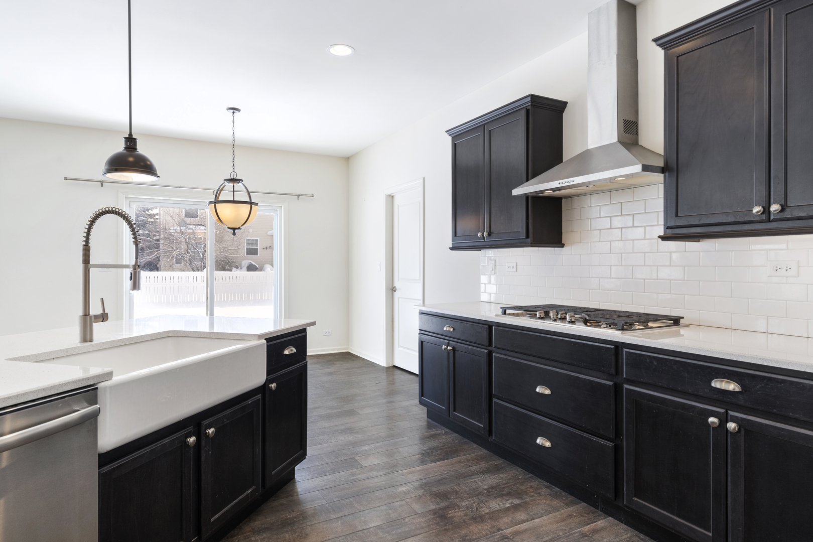 485 Stone Bluff Drive Romeoville, IL 60446 - Photo 11 of 35 a kitchen with stainless steel appliances granite countertop a sink a stove and a wooden floors
