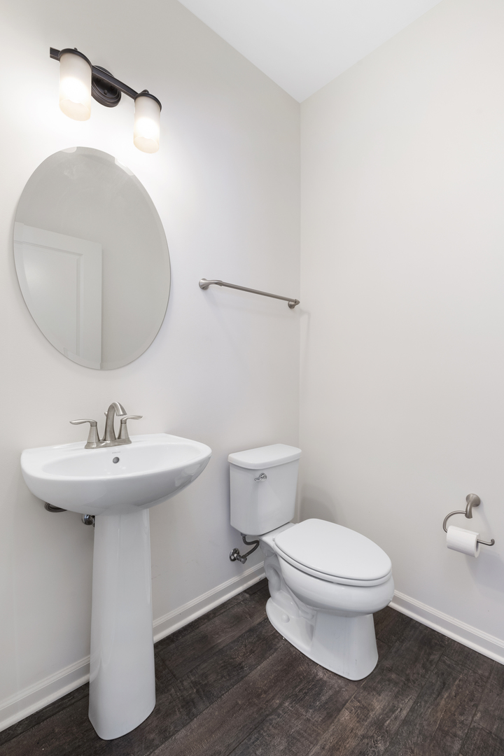 485 Stone Bluff Drive Romeoville, IL 60446 - Photo 19 of 35 a bathroom with a sink a toilet and mirror