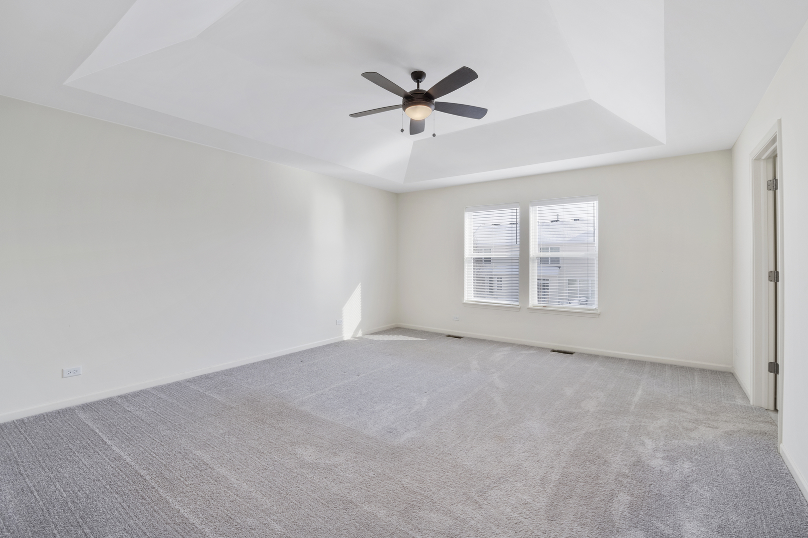 485 Stone Bluff Drive Romeoville, IL 60446 - Photo 20 of 35 an empty room with windows and fan