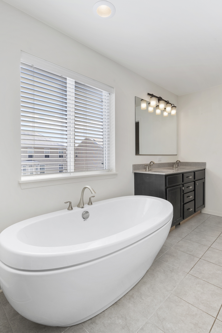485 Stone Bluff Drive Romeoville, IL 60446 - Photo 22 of 35 a white bath tub sitting next to a white sink