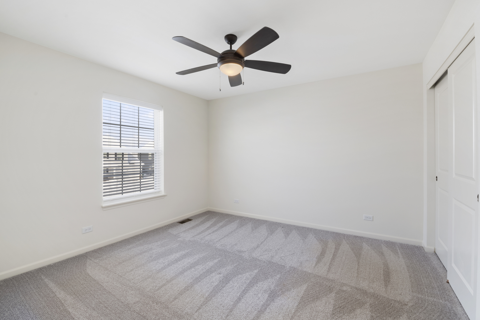 485 Stone Bluff Drive Romeoville, IL 60446 - Photo 25 of 35 an empty room with ceiling fan and windows