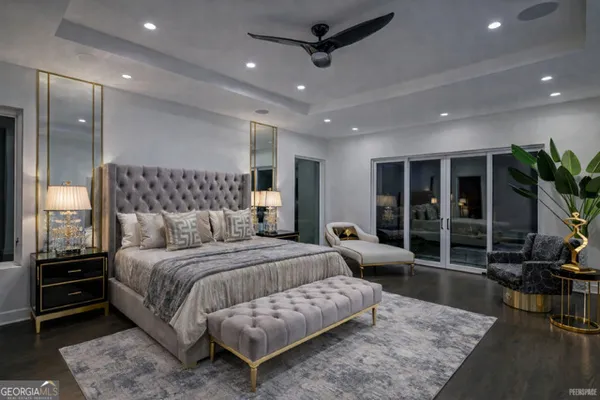 a bedroom with a bed and glass door