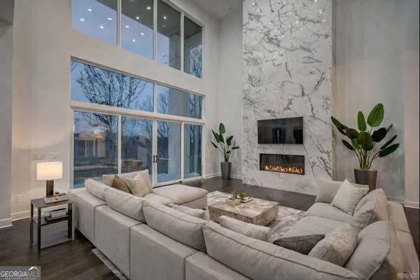 a living room with furniture a fireplace and a flat screen tv