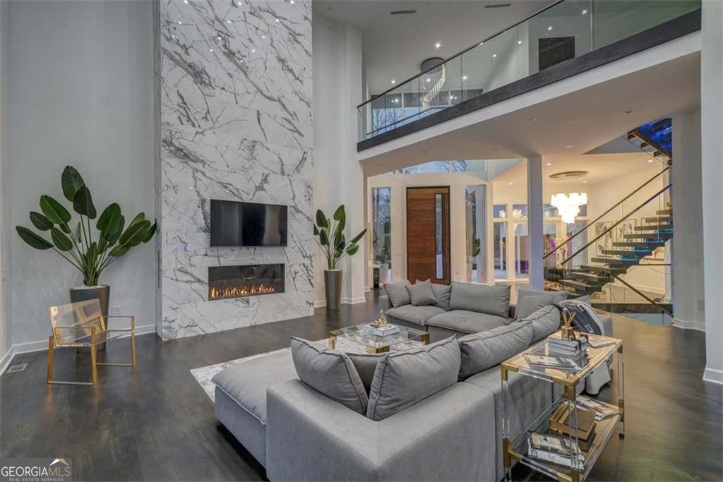 55 Serendipity Way Atlanta, GA 30350 - Photo 7 of 23 a living room with furniture a fireplace a potted plant and a fireplace