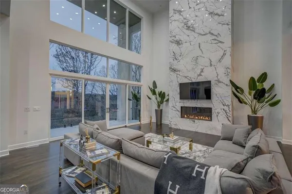 a living room with furniture a fireplace and a potted plant