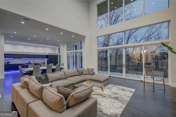 a living room with furniture and a floor to ceiling window