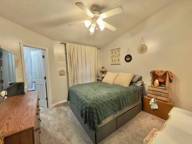 a spacious bedroom with a bed and a chandelier
