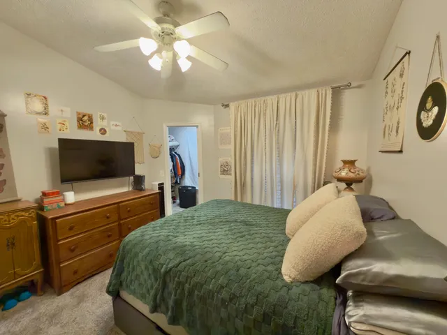 a bedroom with a bed and flat screen tv