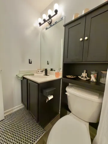 a bathroom with a sink vanity and toilet