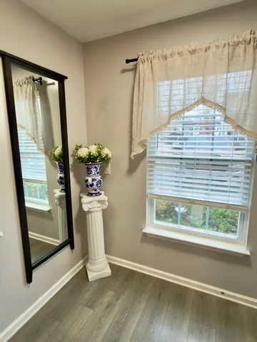 a view of entry way with wooden floor and windows