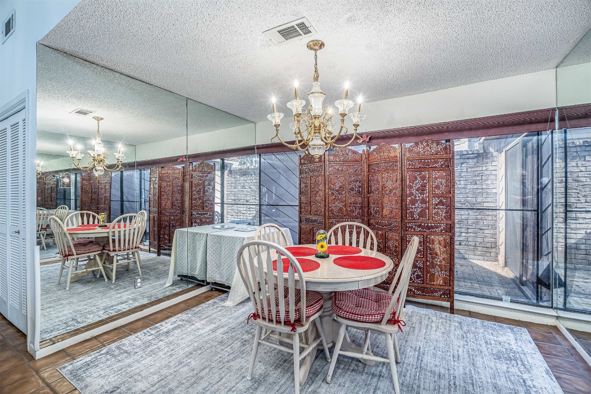 4613 Country Club View Baytown, TX 77521 - Photo 13 of 38 a dining room with furniture a chandelier and wooden floor