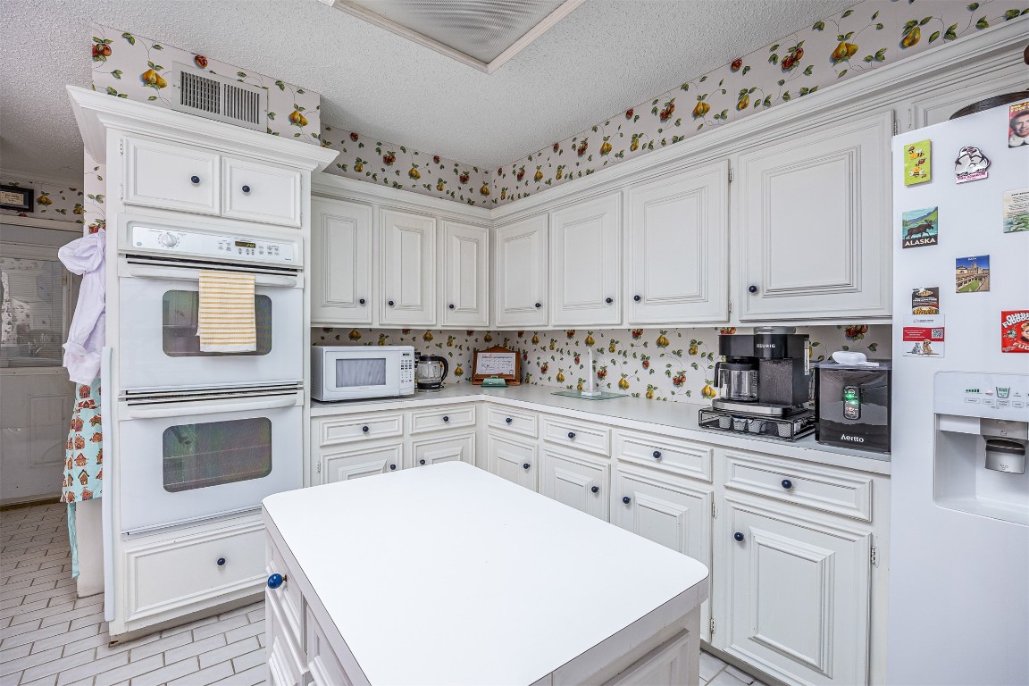 4613 Country Club View Baytown, TX 77521 - Photo 19 of 38 a kitchen with granite countertop white cabinets and white appliances