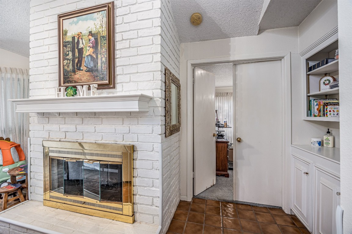 4613 Country Club View Baytown, TX 77521 - Photo 23 of 38 a hallway with a fireplace and baby crib