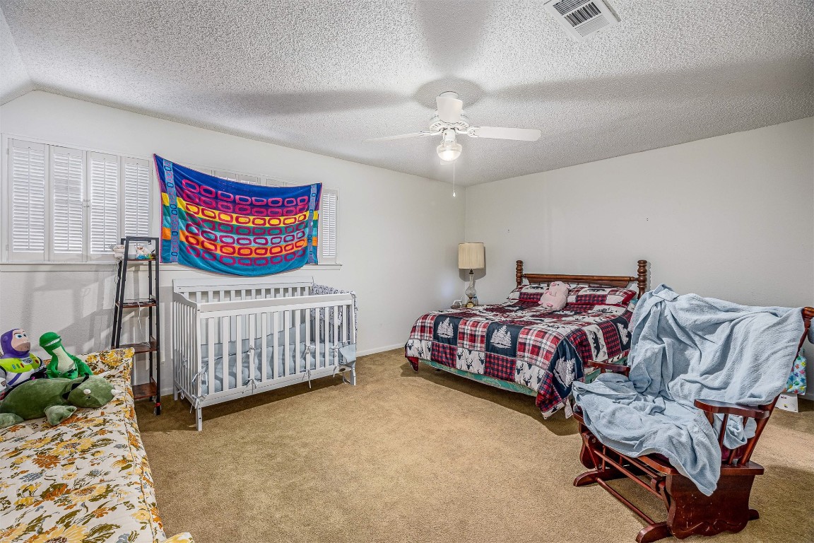 4613 Country Club View Baytown, TX 77521 - Photo 29 of 38 a bedroom with a bed and a chandelier