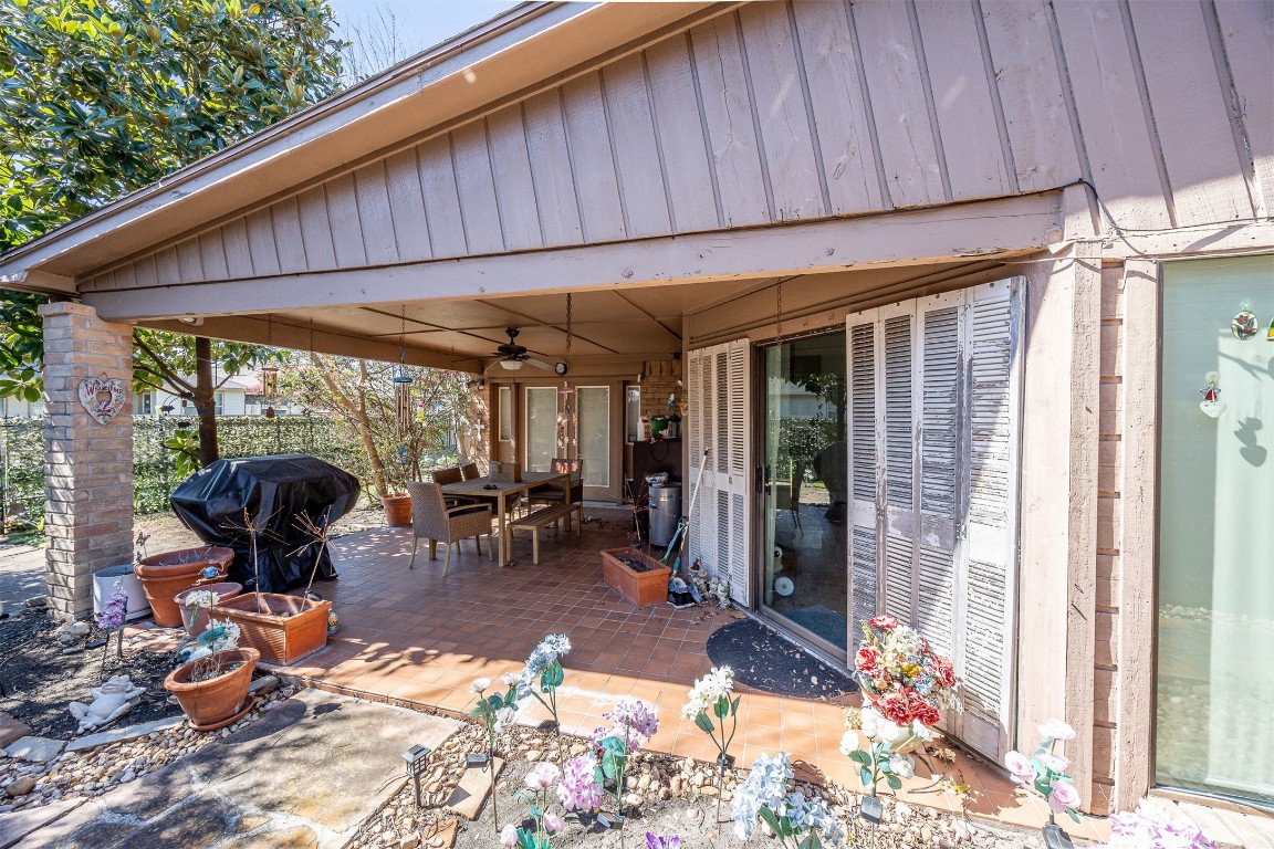 4613 Country Club View Baytown, TX 77521 - Photo 33 of 38 a view of a patio with table and chairs under an umbrella