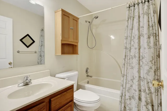 an empty room with a window and a ceiling fan