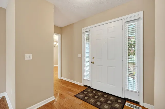 a view of kitchen with wooden floor and cabinets