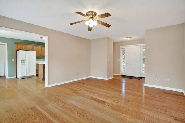 wooden floor in an empty room with a window