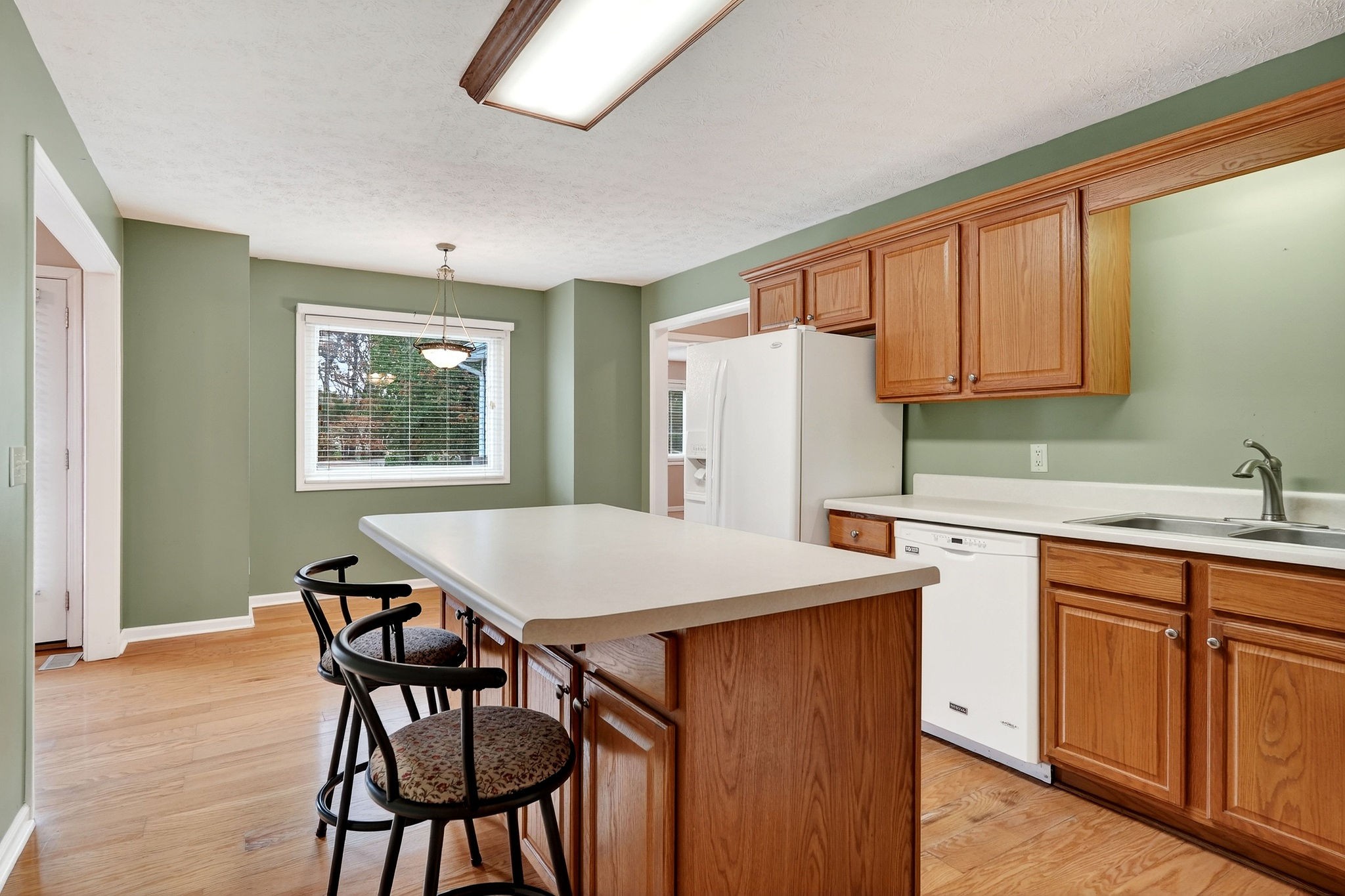 311 Poplar Point Lane Rickman, TN 38580 - Photo 10 of 36 a kitchen with stainless steel appliances granite countertop a table chairs sink refrigerator and granite counter tops