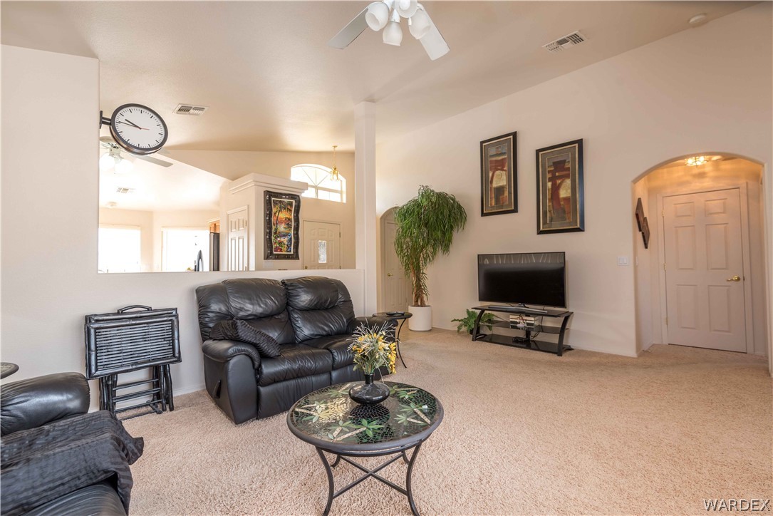 4305 East Cane Ranch Road Kingman, AZ 86401 - Photo 11 of 38 a living room with furniture a fireplace and a flat screen tv