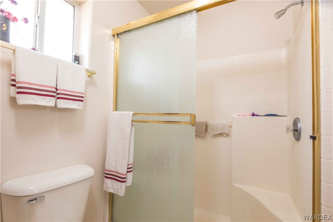 4305 East Cane Ranch Road Kingman, AZ 86401 - Photo 13 of 38 a bathroom with a shower and a toilet