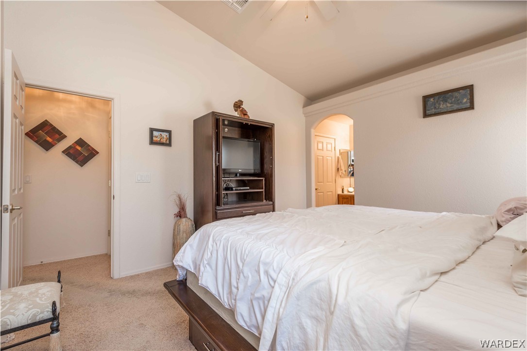 4305 East Cane Ranch Road Kingman, AZ 86401 - Photo 15 of 38 a bedroom with a bed and a large mirror