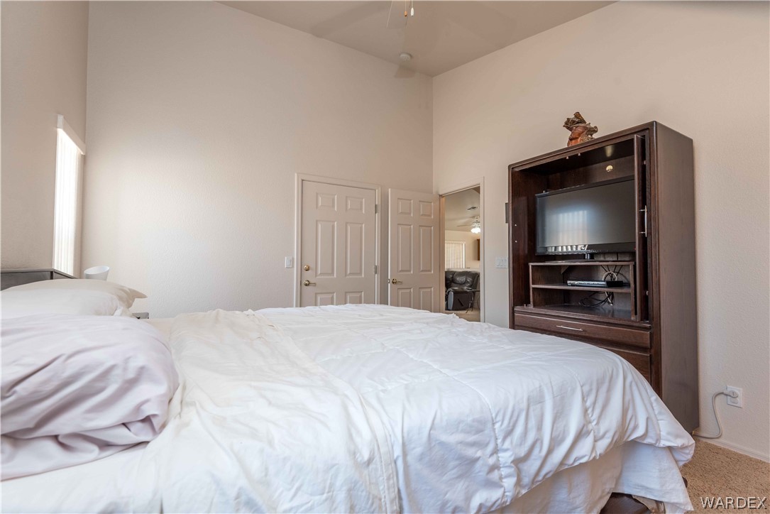 4305 East Cane Ranch Road Kingman, AZ 86401 - Photo 16 of 38 a bedroom with a bed and a television in it