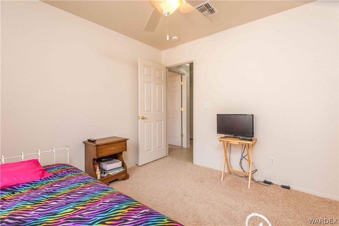 4305 East Cane Ranch Road Kingman, AZ 86401 - Photo 20 of 38 a bedroom with a bed and a television