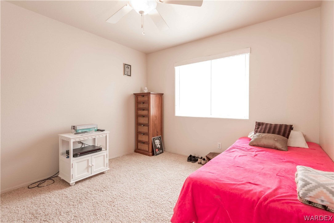 4305 East Cane Ranch Road Kingman, AZ 86401 - Photo 22 of 38 a bedroom with a bed and a window