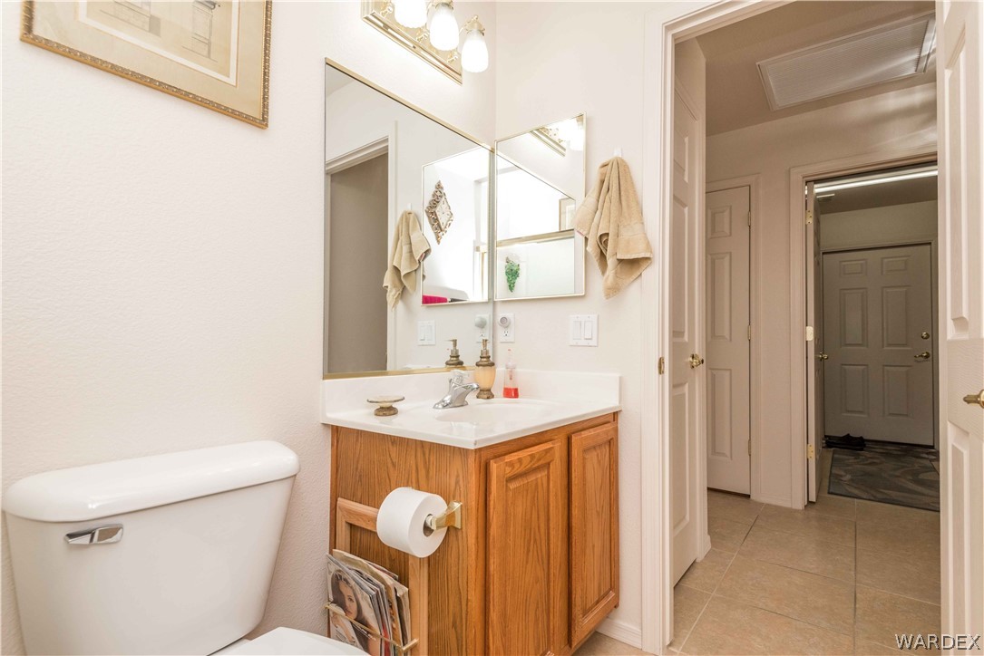 4305 East Cane Ranch Road Kingman, AZ 86401 - Photo 24 of 38 a bathroom with a sink a toilet and a mirror