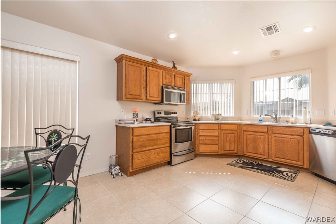 4305 East Cane Ranch Road Kingman, AZ 86401 - Photo 3 of 38 a kitchen with a stove a sink and a refrigerator