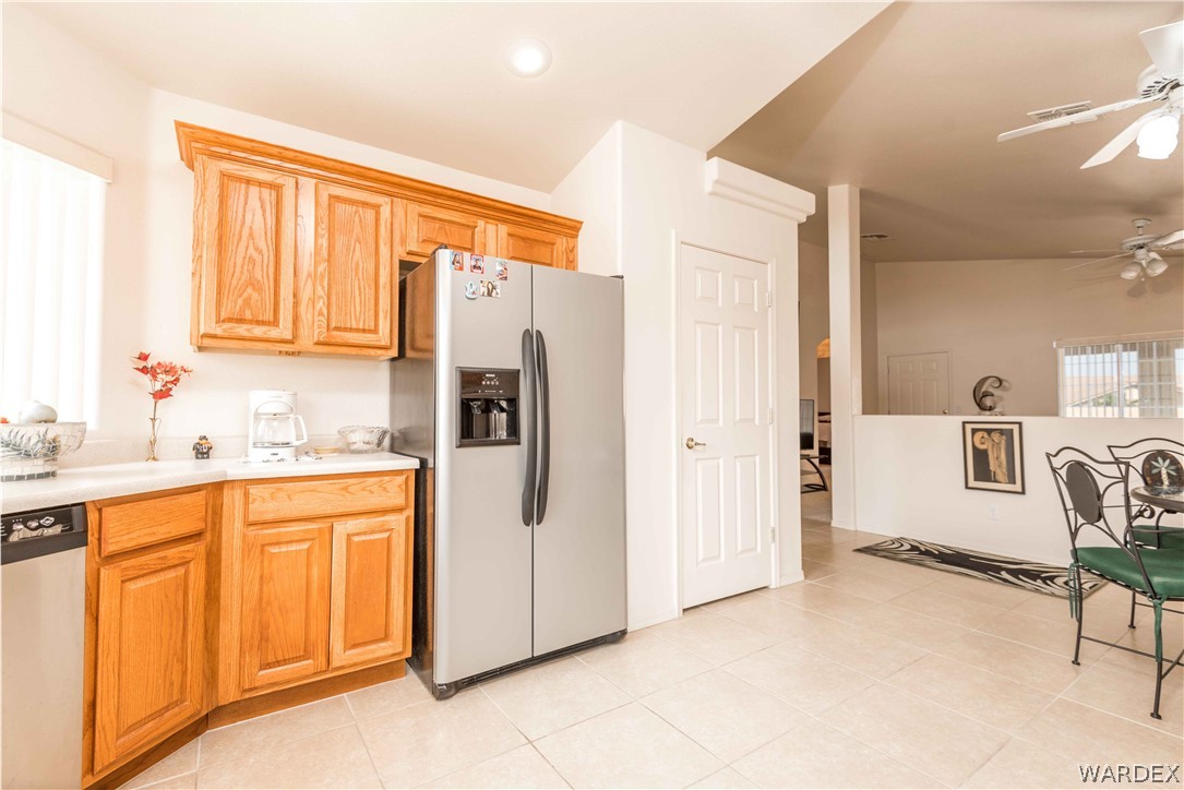 4305 East Cane Ranch Road Kingman, AZ 86401 - Photo 5 of 38 a kitchen with stainless steel appliances a refrigerator and cabinets