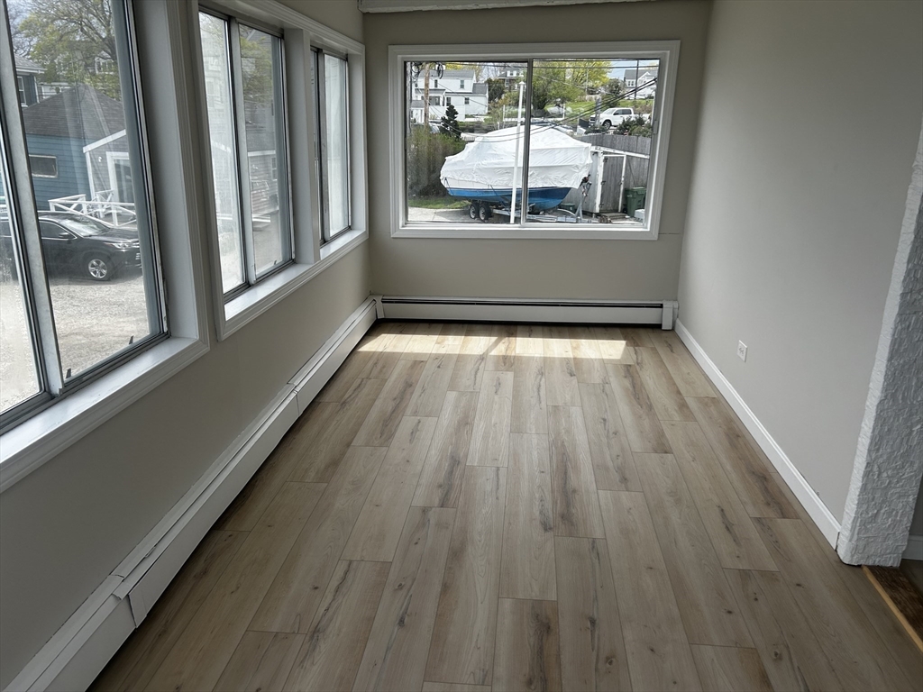 8 Beaver Dam Road, Unit B Scituate, MA 02066 - Photo 7 of 14 a room with wooden floor and a window