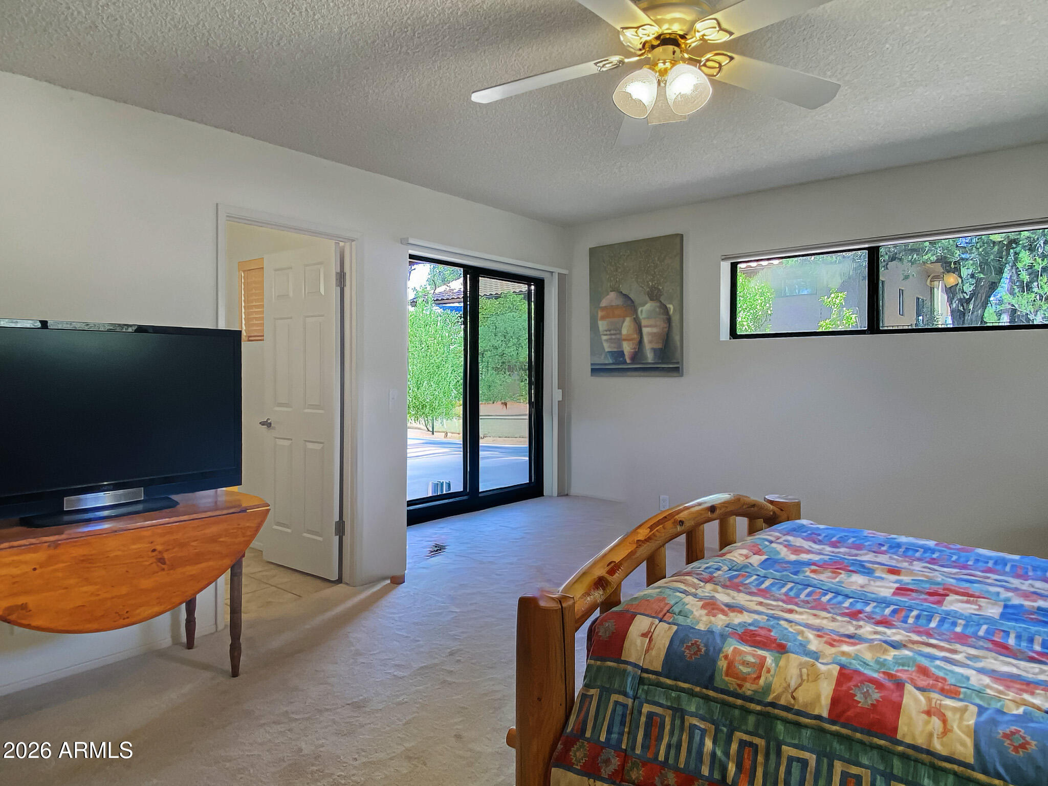 550 Barcelona Road Sedona, AZ 86336 - Photo 17 of 32 a bedroom with a bed and a flat screen tv