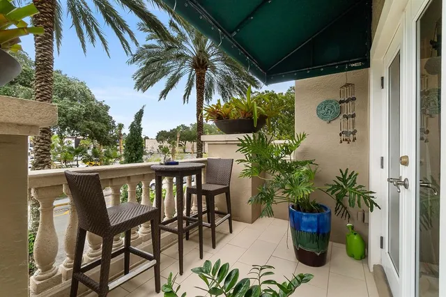 a view of a patio with table and chairs and potted plants