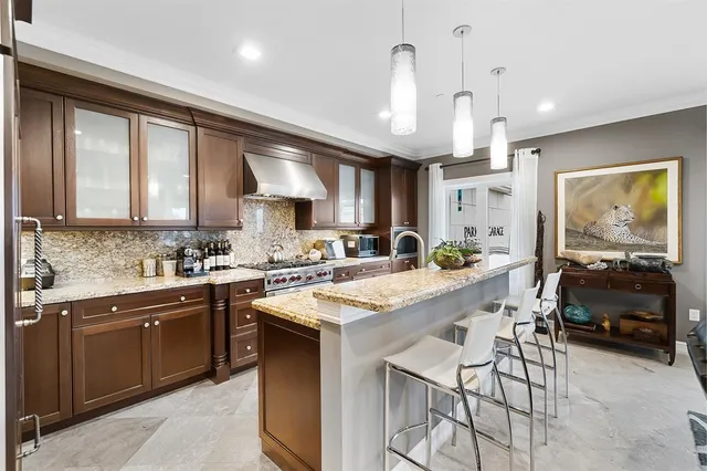 a kitchen with stainless steel appliances kitchen island granite countertop a sink and cabinets