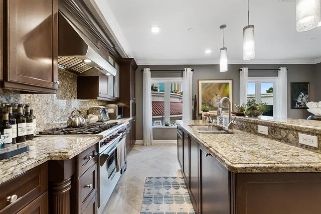a kitchen with granite countertop stainless steel appliances and wooden cabinets