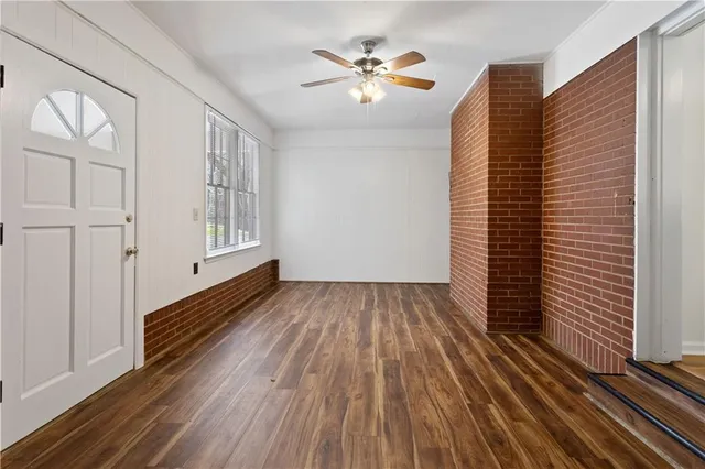 wooden floor in an empty room with a window