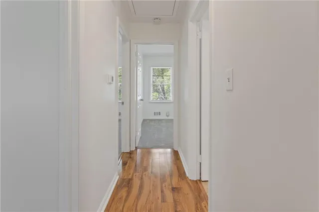 a view of a hallway with wooden floor