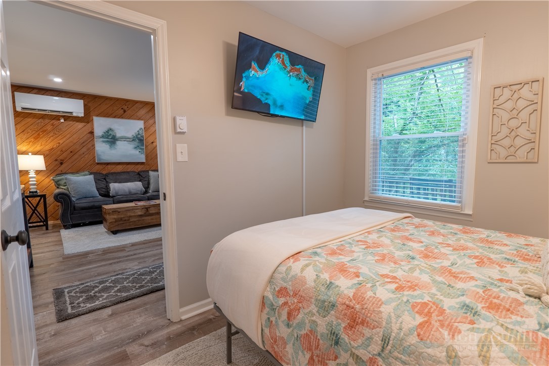 141 Snowflake Road Banner Elk, NC 28604 - Photo 7 of 28 a bedroom with a bed and wooden floor
