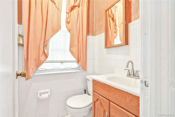 a bathroom with a sink a toilet and a window