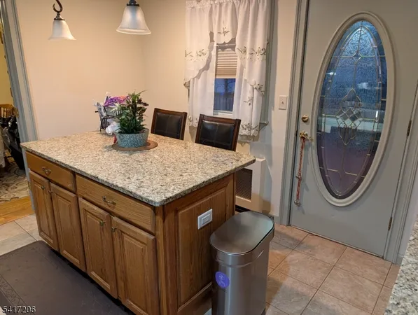 a bathroom with a granite countertop sink a mirror and a shower