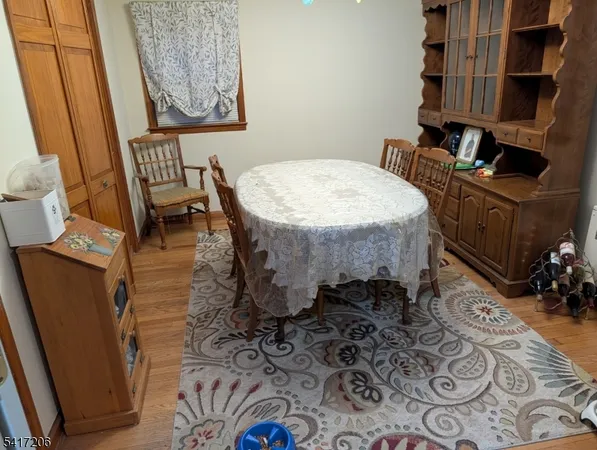 a dining room with furniture and wooden floor