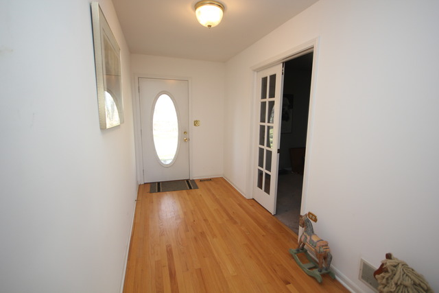 9-n301 Percy Road Maple Park, IL 60151 - Photo 2 of 25 a view of a livingroom with wooden floor and a window