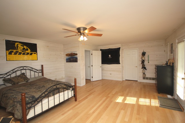 9-n301 Percy Road Maple Park, IL 60151 - Photo 13 of 25 a bedroom with a large bed a flat tv screen and dresser